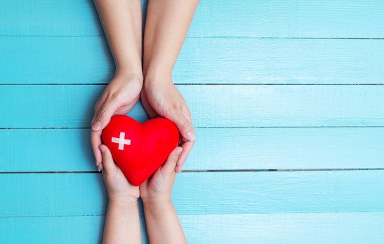 two people holding a heart