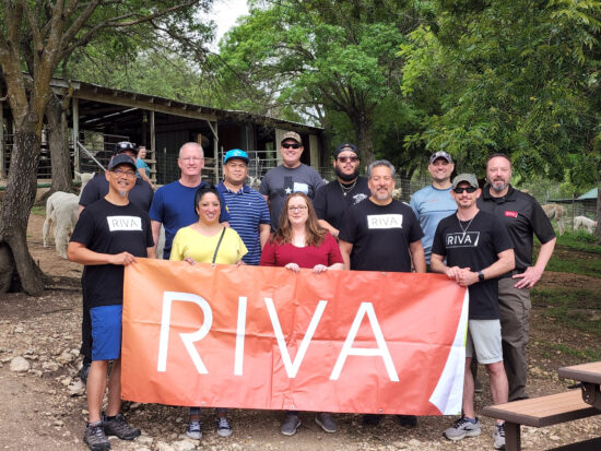 Team RIVA with banner