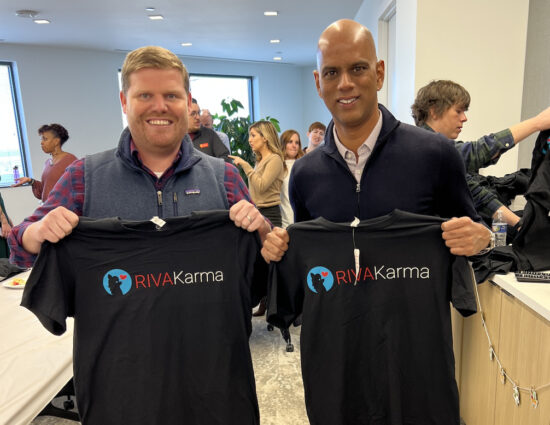 Two men holding up RIVA Karma tshirts